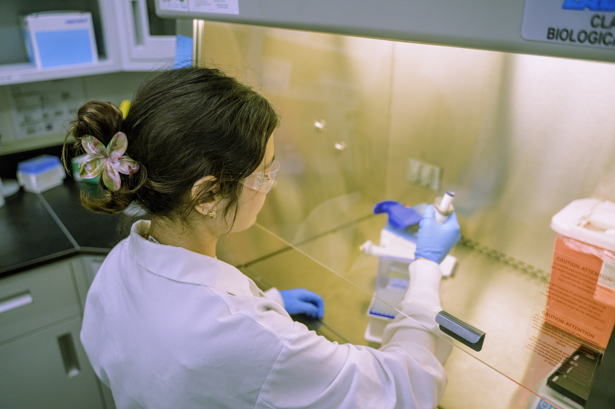 HPC Foods Laboratory team members working together in the lab, wearing lab coats and gloves while analyzing samples
